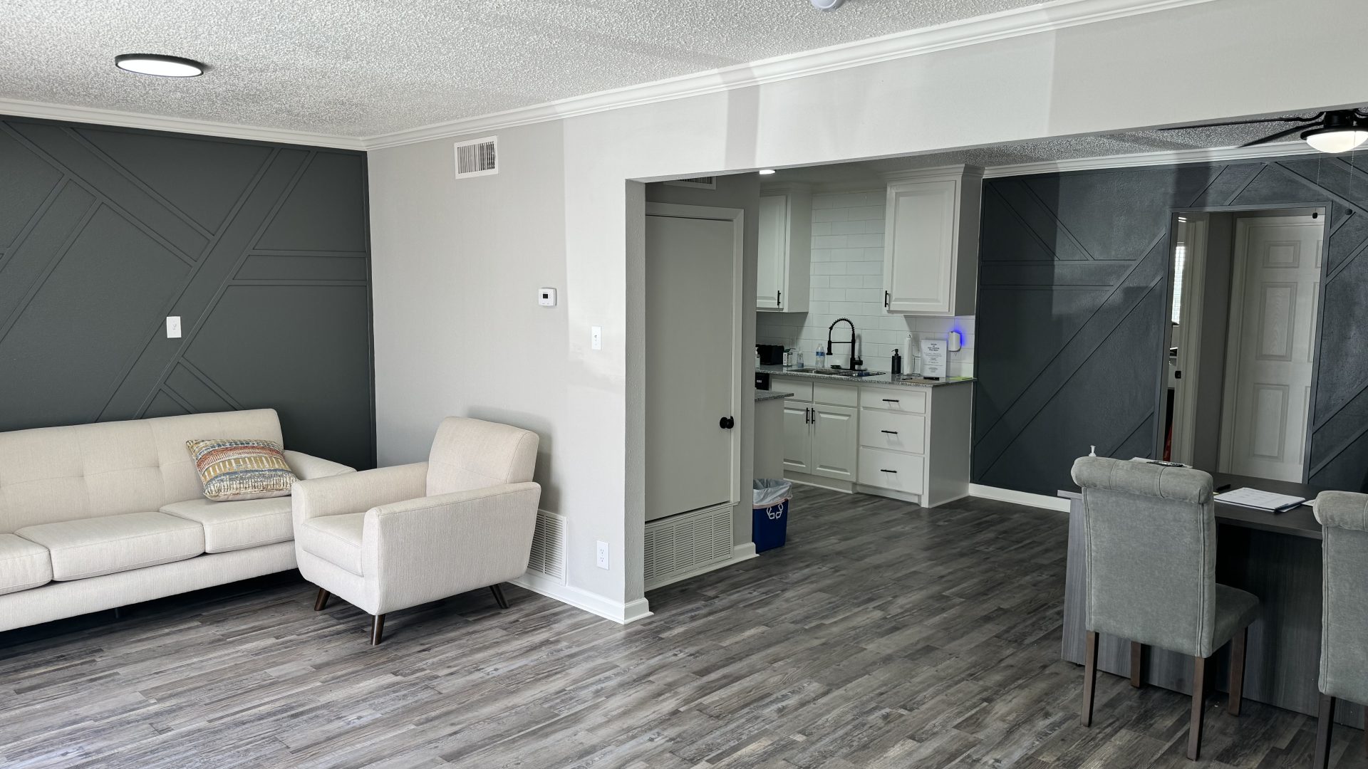 a living room with hardwood floors and gray walls at The  Landing Apartments