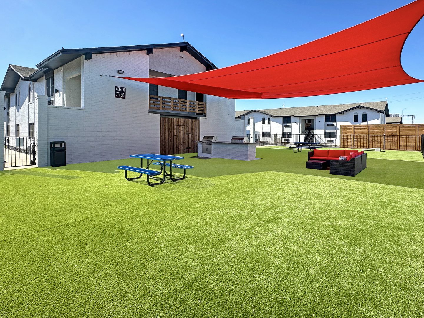 a patio with a red awning and picnic table at The  Landing Apartments